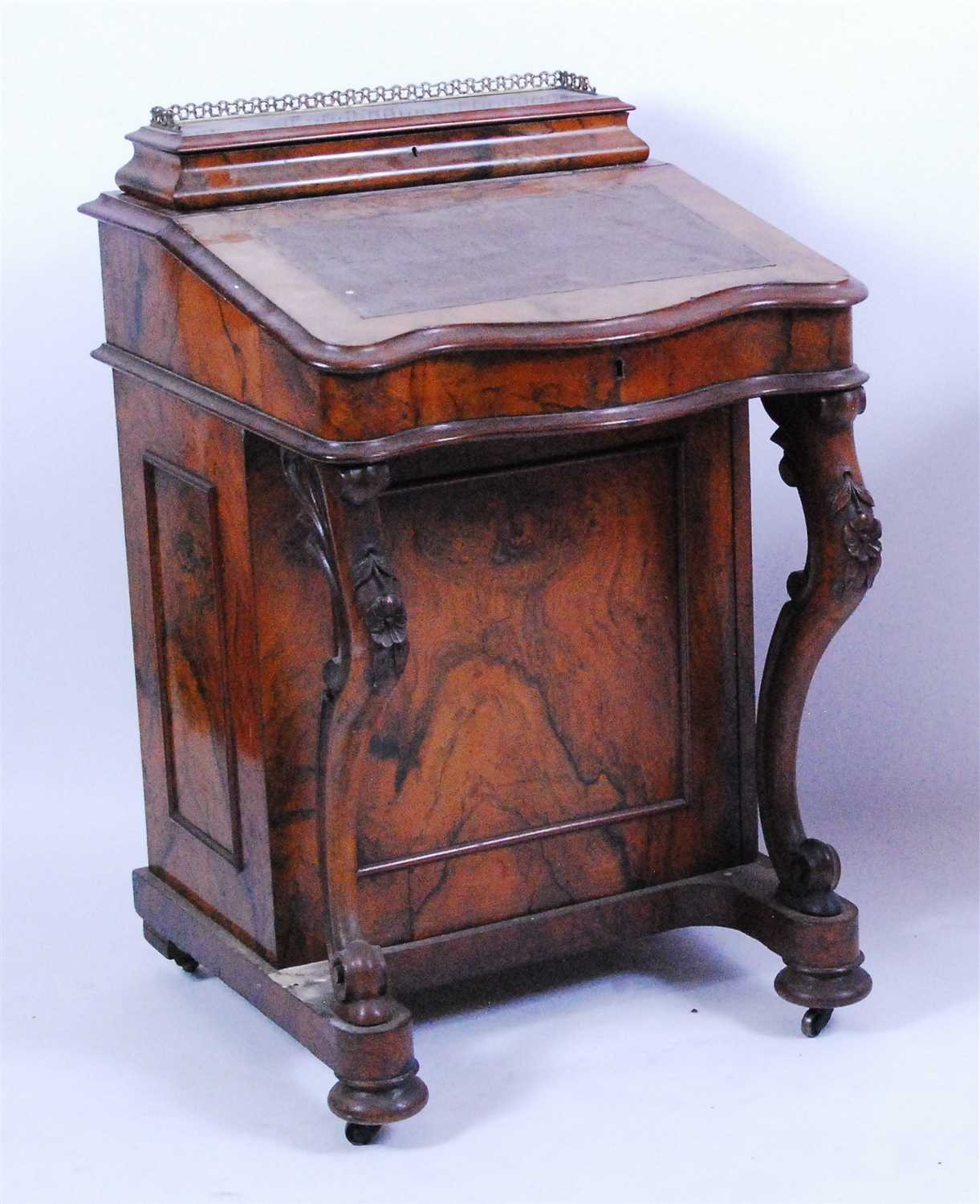 Lot 1414 - A Victorian figured walnut kneehole writing...