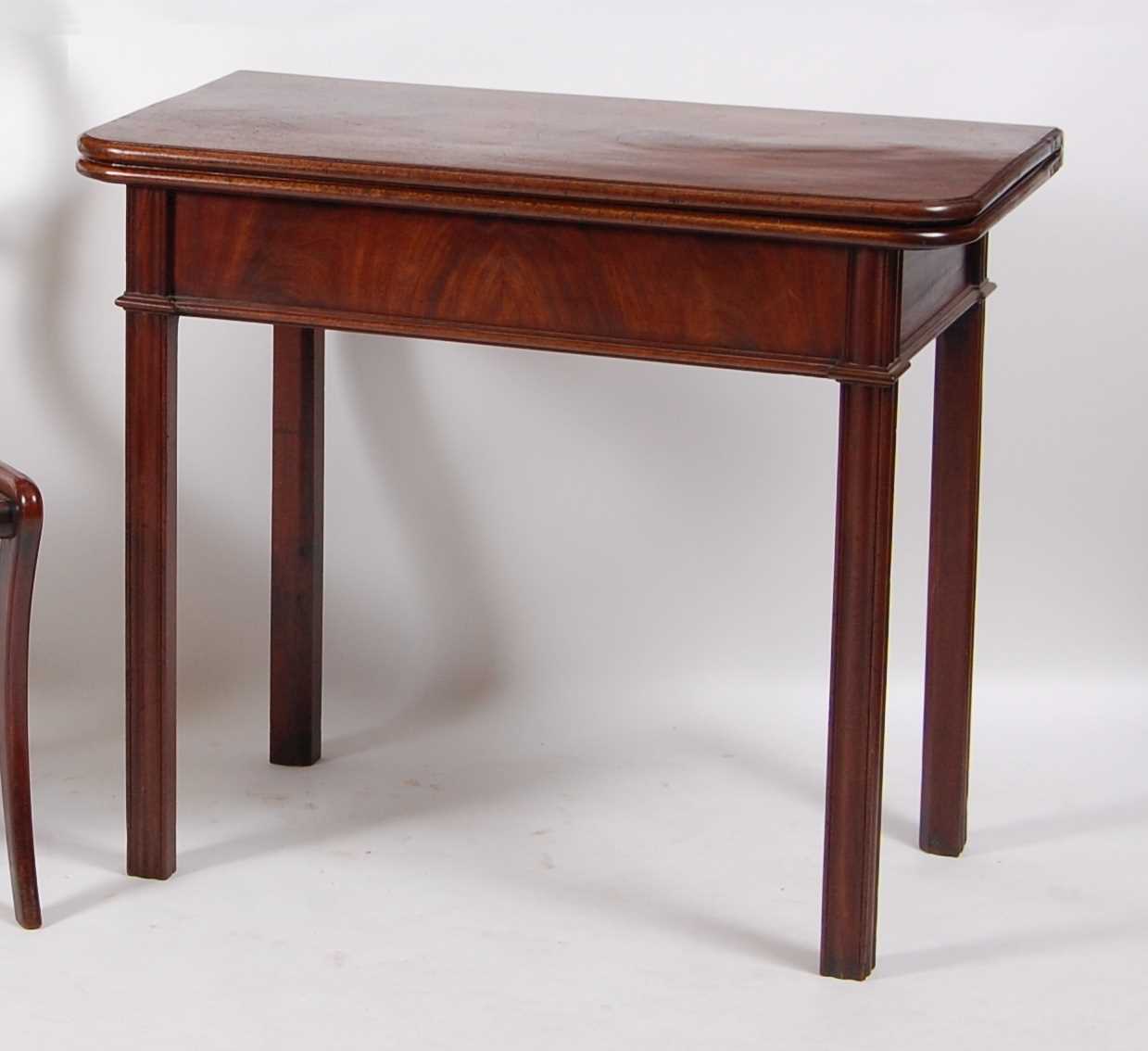 Lot 1462 - A George III mahogany tea table, having a fold-...
