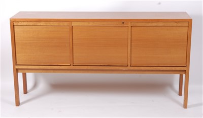 Lot 436 - A 1970s teak sideboard, having three roller...