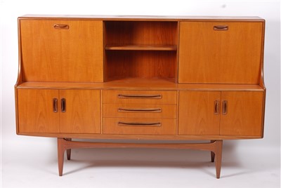 Lot 437 - A 1970s G-Plan teak side cupboard, the raised...