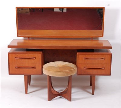 Lot 439 - A 1970s G-Plan teak kneehole long dressing...