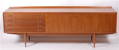 Lot 444 - A 1960s English teak long sideboard, having...