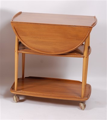 Lot 504 - A 1960s Ercol blond elm dropflap three-tier...