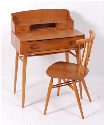 Lot 510 - A 1960s Ercol blond elm writing bureau, having...