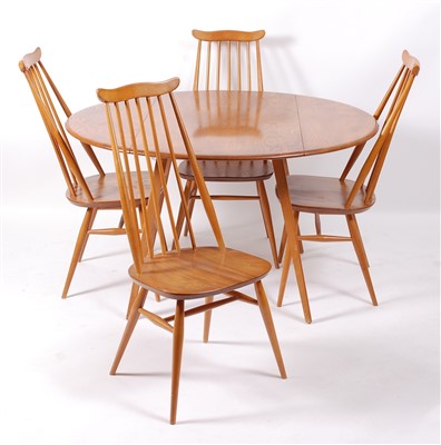 Lot 509 - A 1960s Ercol blond elm dining suite,...