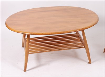 Lot 507 - A 1960s Ercol blond elm oval low coffee table,...