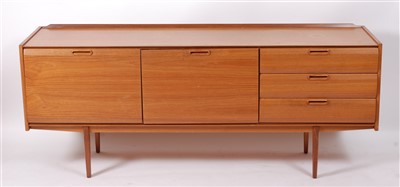 Lot 445 - A 1960s teak long sideboard, having slightly...