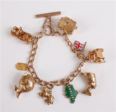 Lot 2551 - A 9ct yellow gold curb link charm bracelet,...