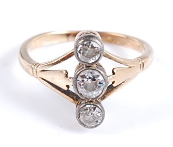Lot 2602 - A yellow metal three-stone diamond ring, the...