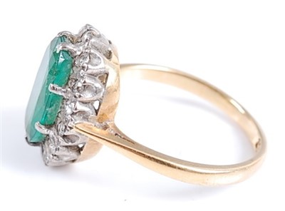 Lot 2587 - An 18ct yellow and white gold, oval emerald...