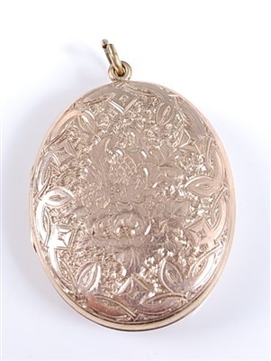 Lot 2594 - A yellow metal engraved oval locket, having...