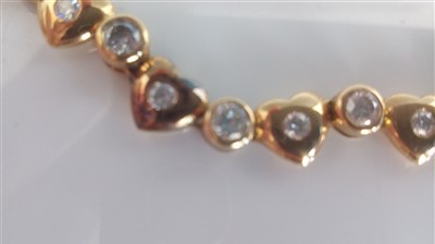 Lot 1209 - A yellow metal diamond necklet, having...