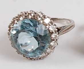 Lot 1183 - A white metal, aquamarine and diamond circular...