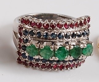 Lot 1186 - A white metal, emerald, sapphire and ruby...