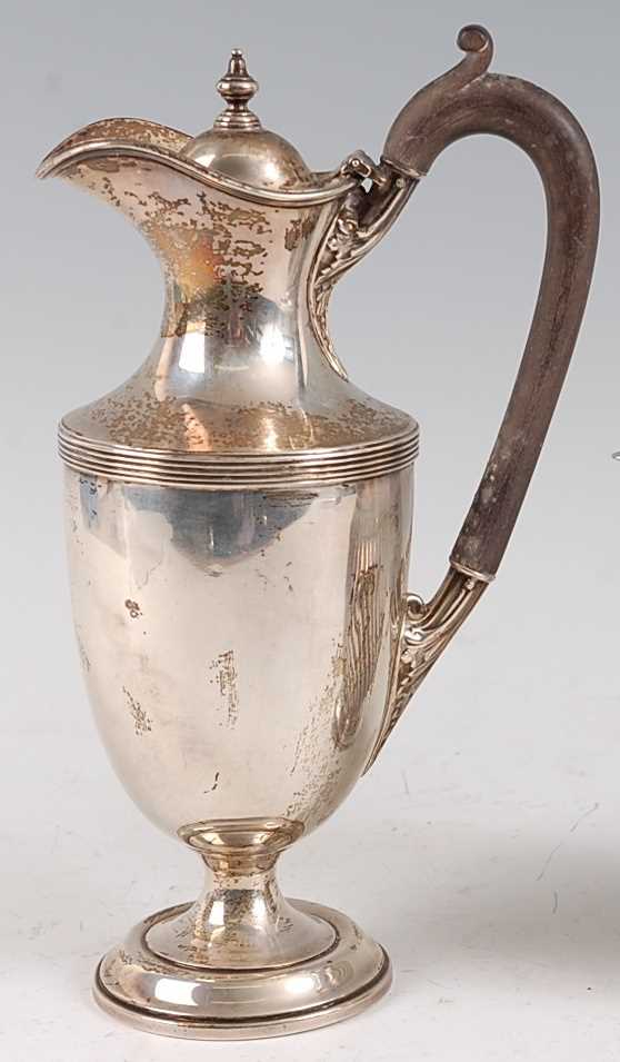Lot 1083 - A George V silver hot water jug, the cover...