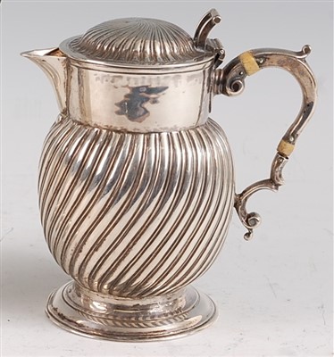 Lot 1084 - A George III silver hot water jug, the hinged...