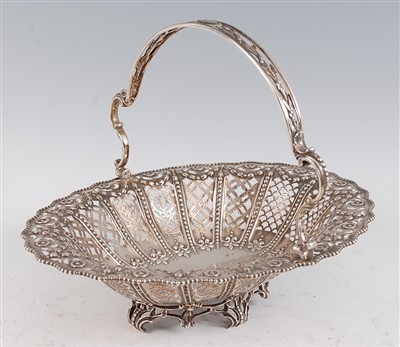 Lot 1085 - A George V silver basket, of pierced oval form...