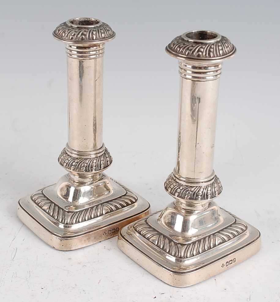 Lot 1114 - A pair of Edwardian silver table candlesticks,...