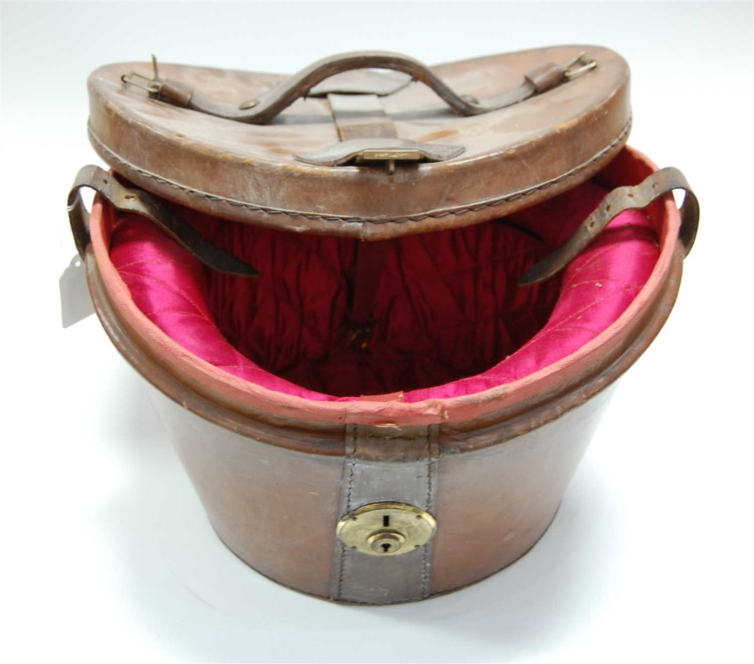 Lot 15 - An Edwardian brown leather top-hat box, having...