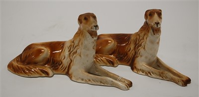Lot 170 - A pair of Royal Dux porcelain recumbent dogs,...