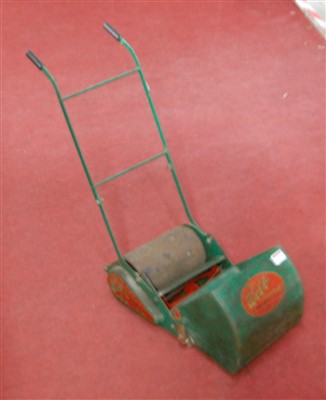 Lot 66 - A child's push-along lawn mower, with grass...