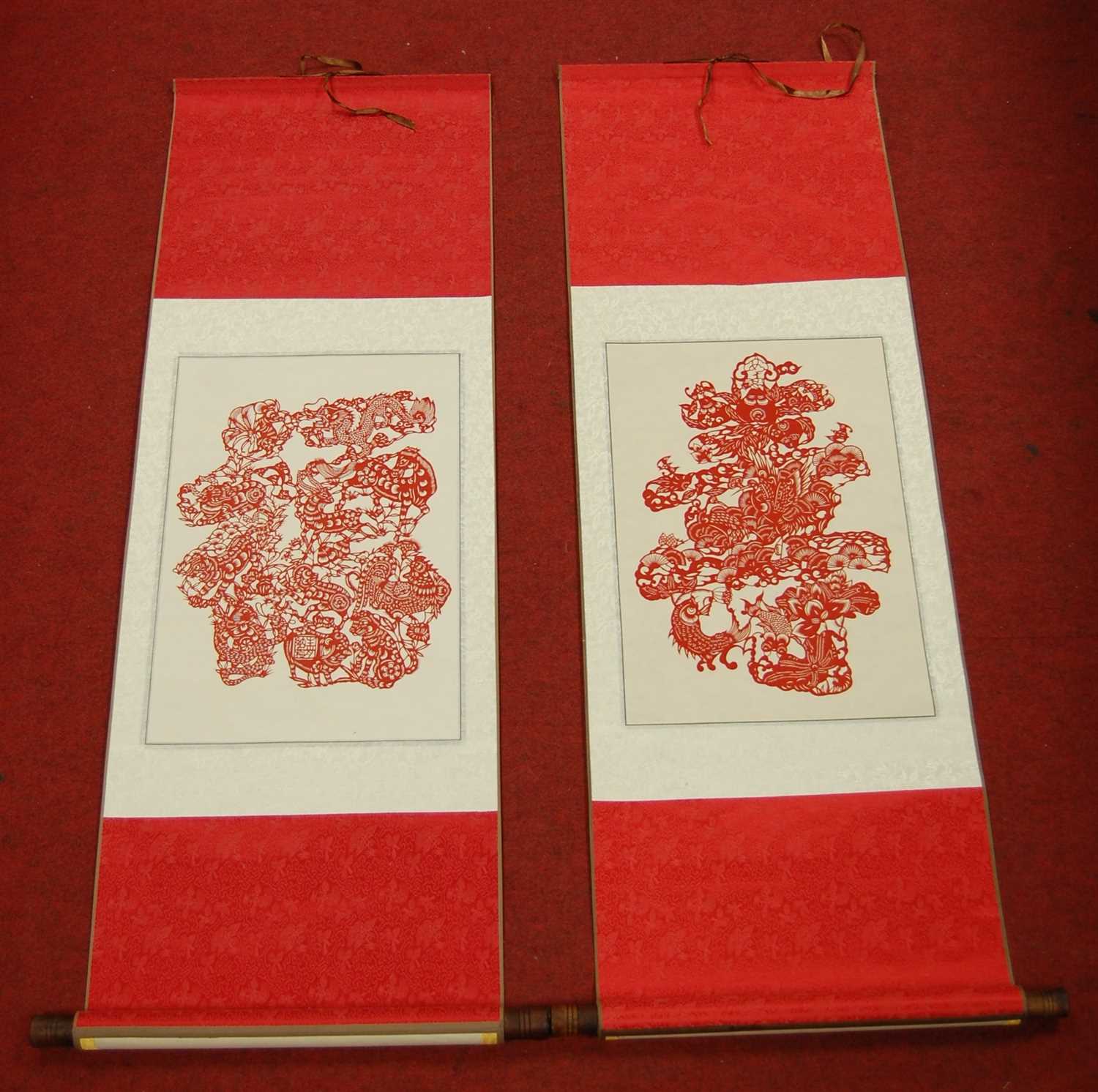 Lot 83 - A Chinese red and white silk scroll, depicting...