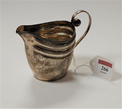 Lot 205 - A 19th century white metal cream jug of helmet...