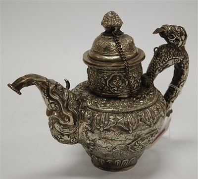 Lot 209 - An eastern white metal and embossed teapot and...
