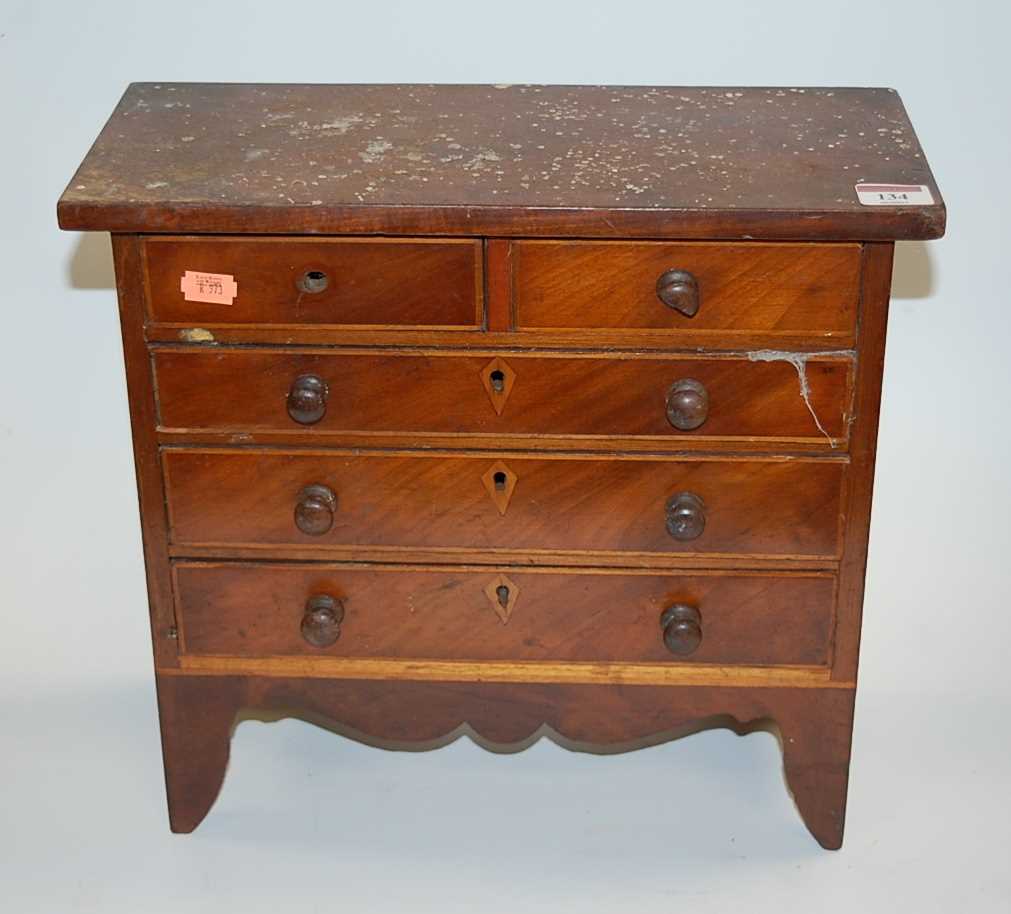 Lot 134 - A mahogany apprentice piece chest of two short...