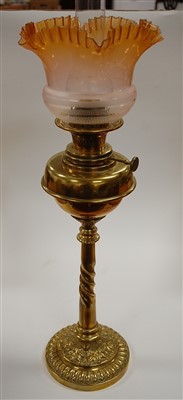 Lot 107 - A late Victorian oil lamp having amber tinted...