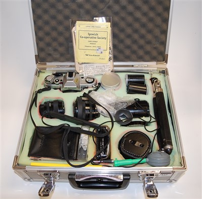Lot 125 - A Canon AE1 camera in fitted case with various...