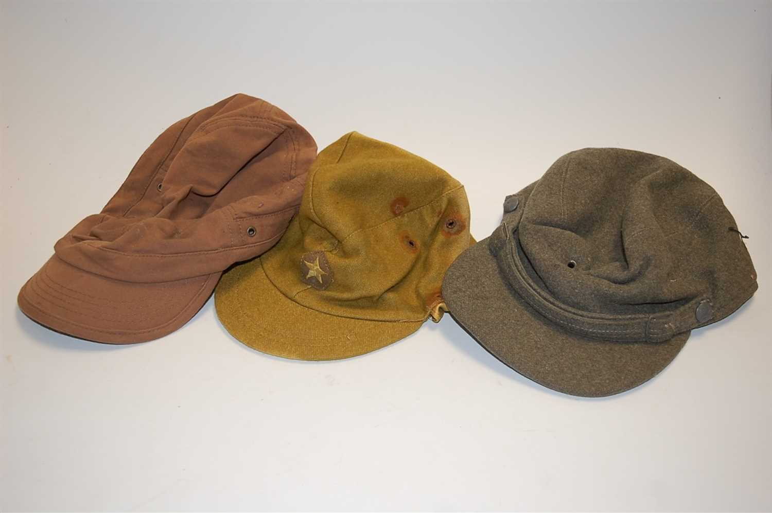 Lot 239 - A military style fatigue cap; and two others (3)