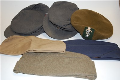 Lot 245 - A collection of military headgear, to include...