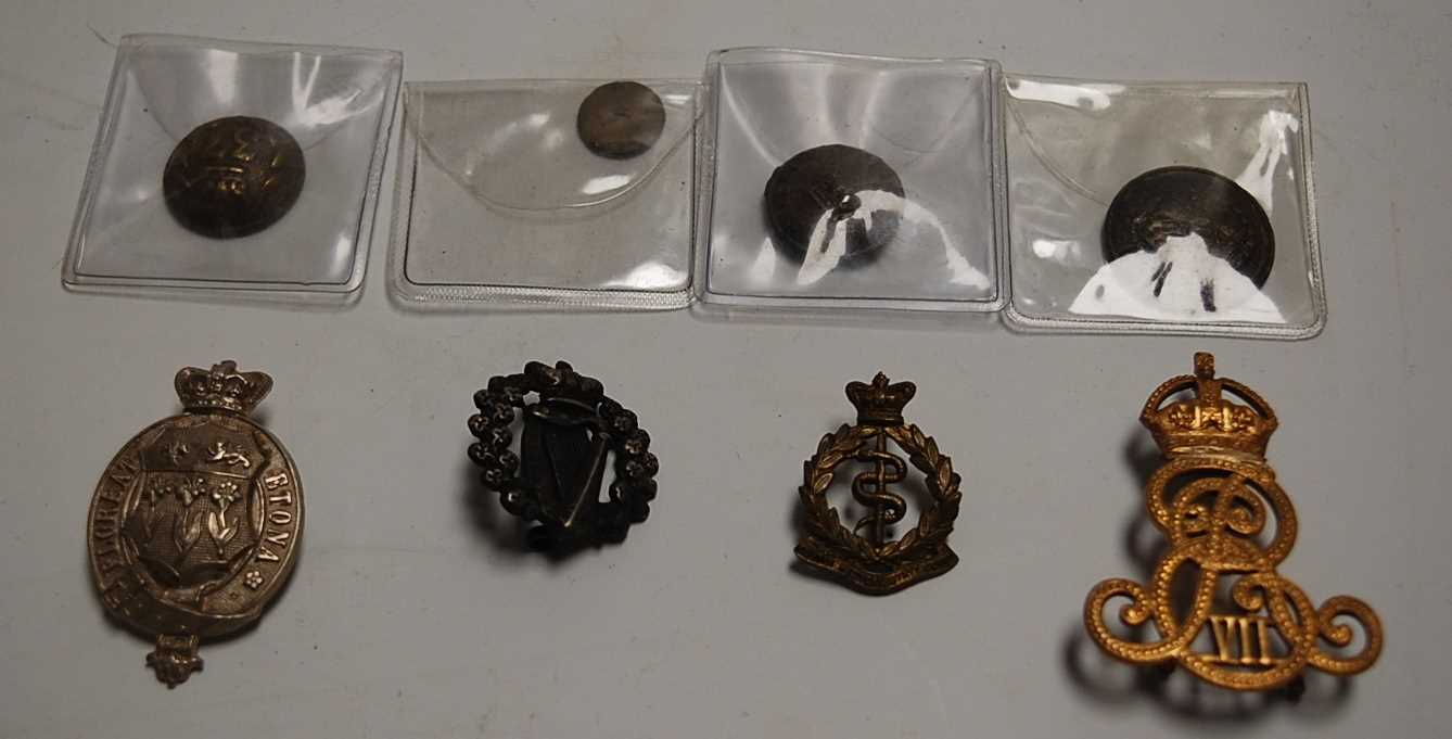 Lot 266 - A small collection of military cap badges,...