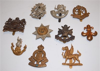 Lot 267 - A collection of 11 various military cap badges...