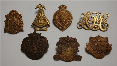 Lot 270 - A small collection of military cap badges and...