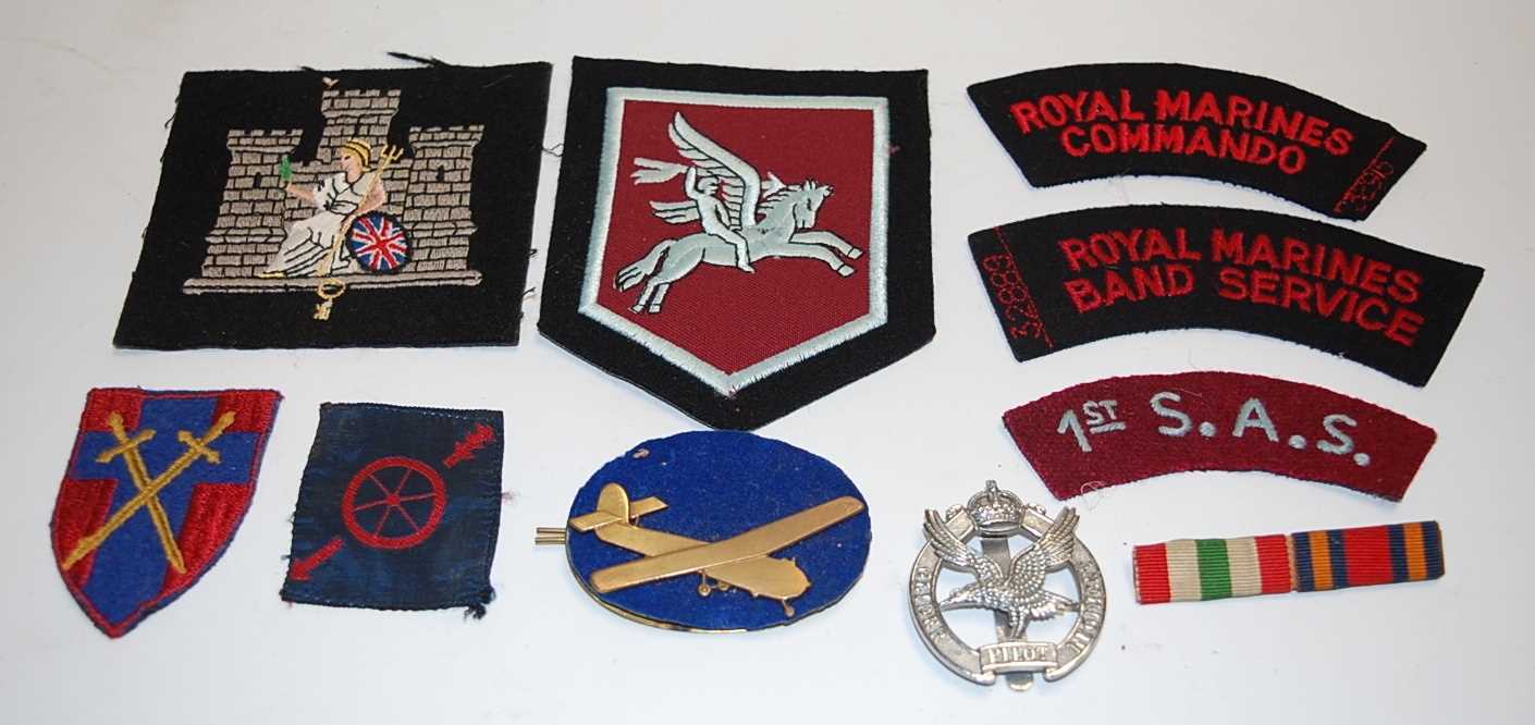 Lot 272 - A collection of various military cloth badges...