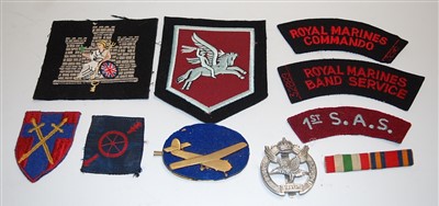 Lot 272 - A collection of various military cloth badges...