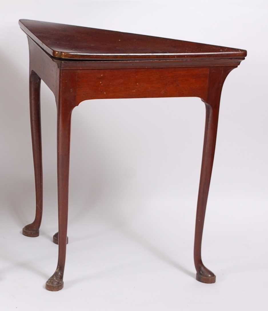Lot 1474 - A George II walnut corner writing table, the...