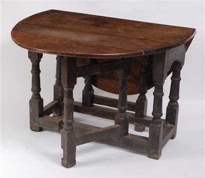 Lot 1476 - A circa 1700 joined oak dropleaf table, having...