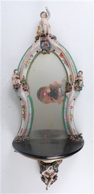 Lot 1006 - A 19th century German porcelain wall mirror,...