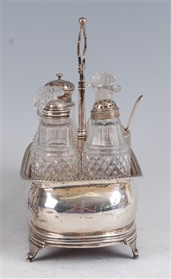 Lot 1141 - A George III silver seven bottle cruet stand,...