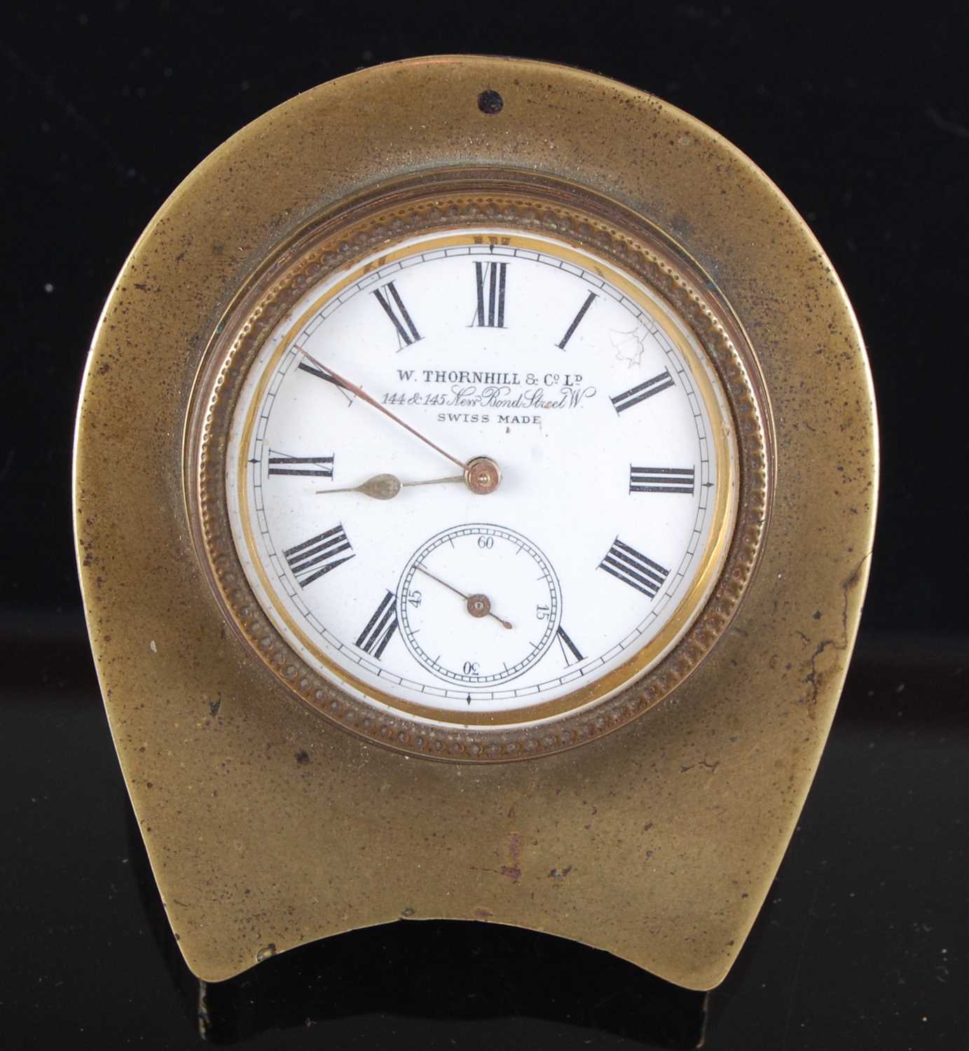 Lot 1389 - A late Victorian brass cased travel clock, the...