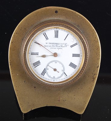 Lot 1389 - A late Victorian brass cased travel clock, the...