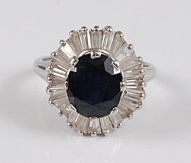 Lot 1228 - A white metal sapphire and diamond oval...