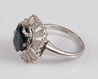 Lot 1228 - A white metal sapphire and diamond oval...