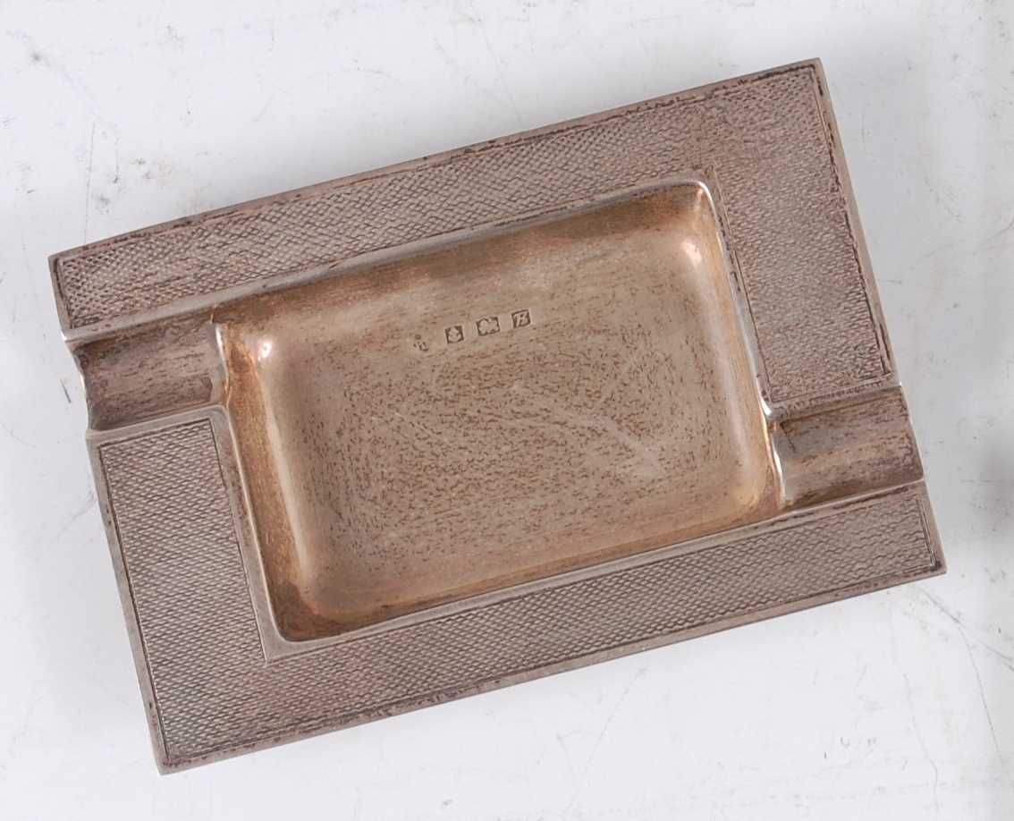 Lot 239 - A 1960s silver ashtray, having engine turned...