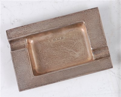 Lot 239 - A 1960s silver ashtray, having engine turned...