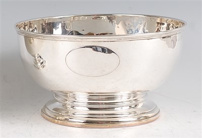 Lot 1165 - An Edwardian silver punch bowl, raised on...