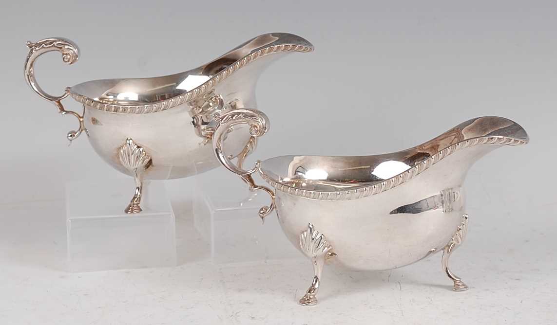 Lot 1166 - A pair of Georgian style silver sauceboats,...